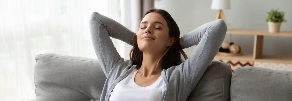 Rehab FAQs answered, as shown by woman in relaxed pose